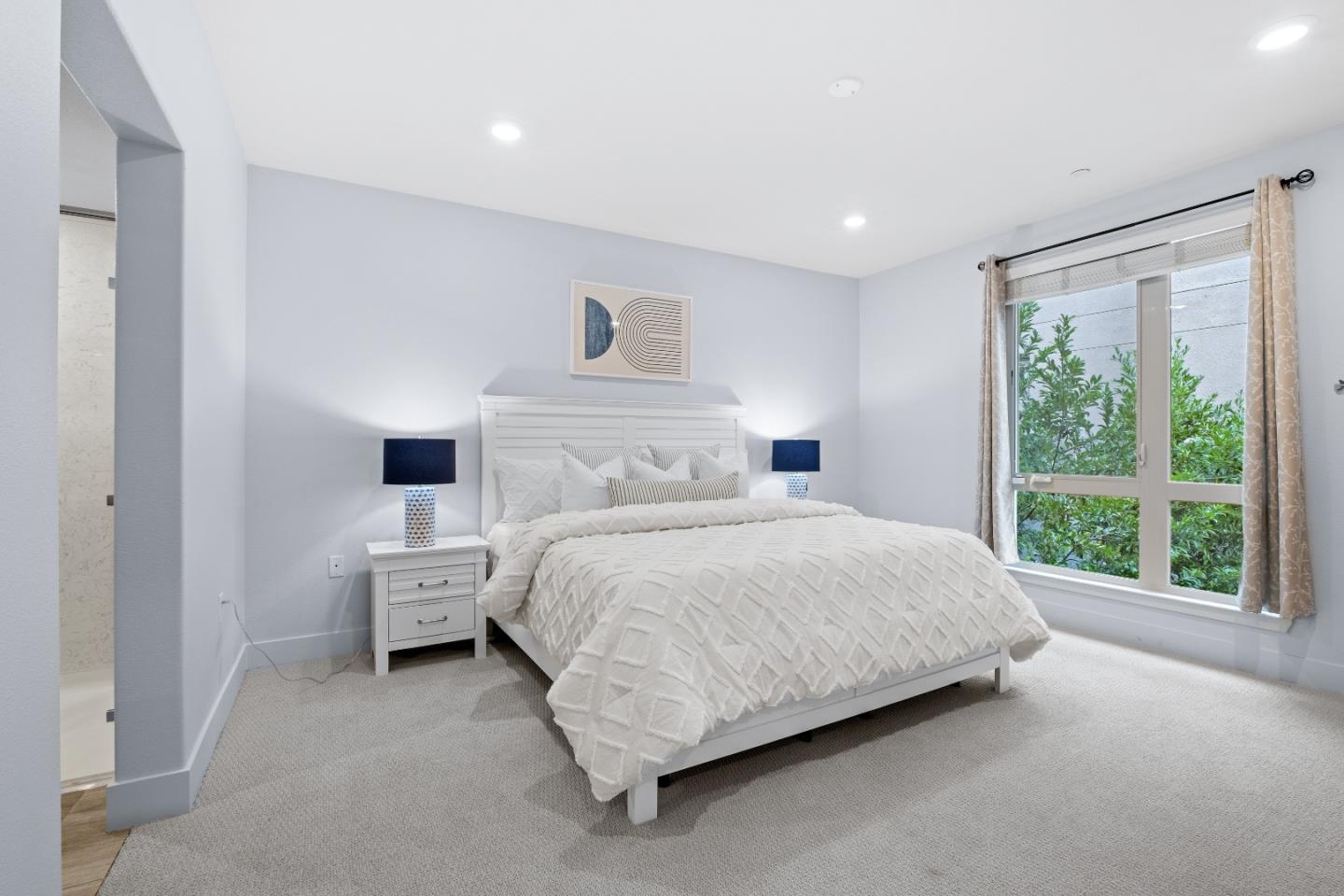 330 Riesling Avenue, Unit 23 Milpitas, CA 95035 - Photo 23 of 51 a bedroom with a bed and a large window