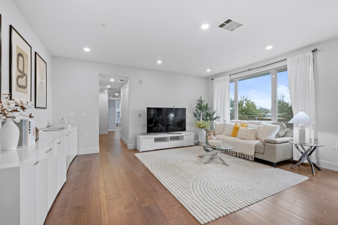 330 Riesling Avenue, Unit 23 Milpitas, CA 95035 - Photo 4 of 51 a living room with furniture and a flat screen tv
