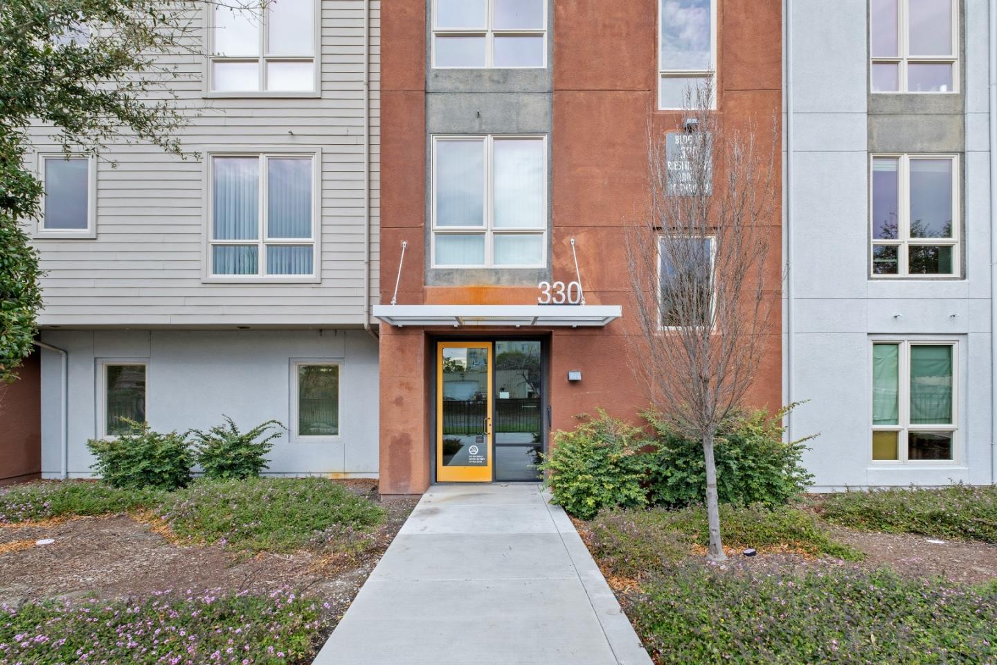 330 Riesling Avenue, Unit 23 Milpitas, CA 95035 - Photo 44 of 51 a front view of a house with a garden