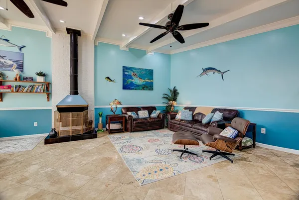 a living room with furniture and a ceiling fan