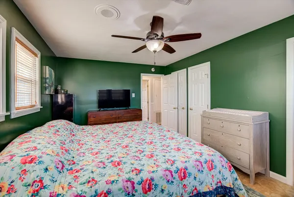 a bedroom with a bed and a dresser