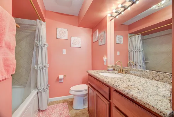 a bathroom with a granite countertop sink toilet and shower