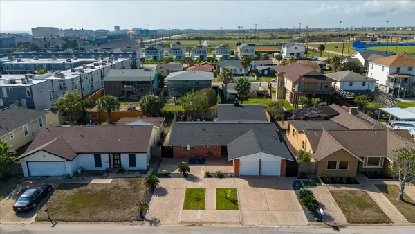 an aerial view of residential houses with outdoor space
