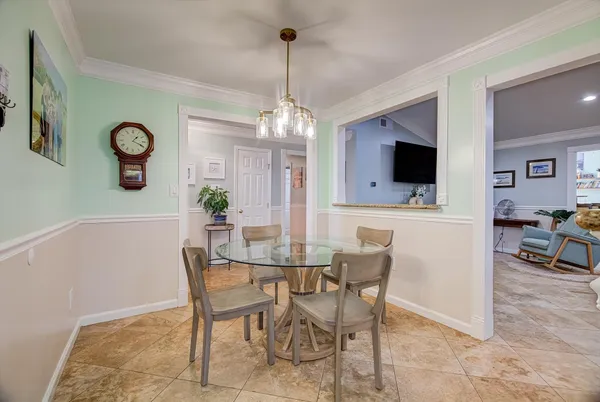 a view of a dining room with furniture and a chandelier