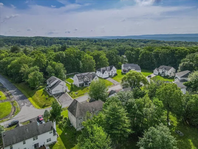 a view of a dining room with furniture a chandelier and wooden floor