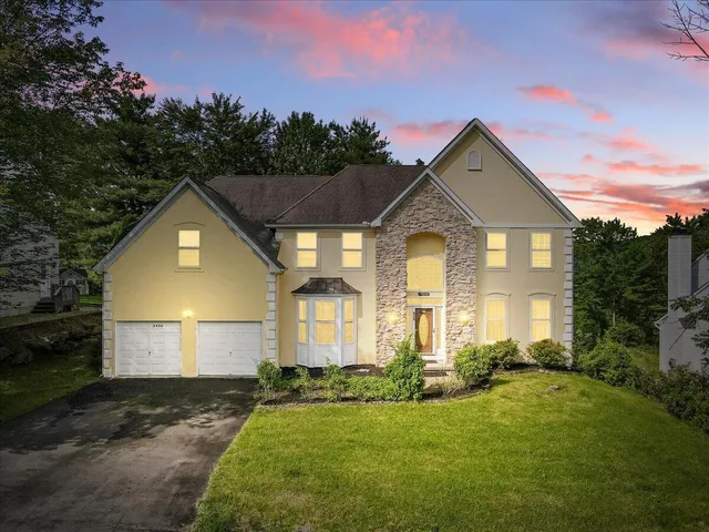 a front view of a house with a yard and garage