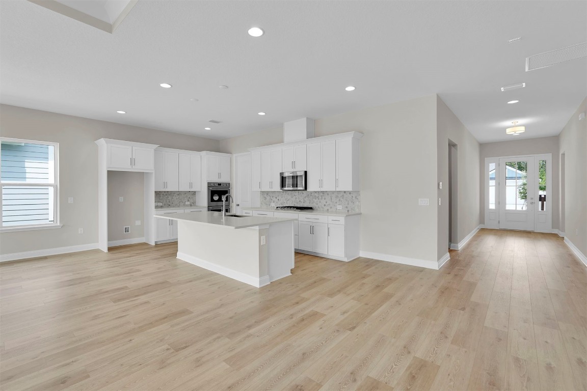 323 Sawgrass Drive Yulee, FL 32097 - Photo 15 of 33 a view of kitchen with wooden floor and window