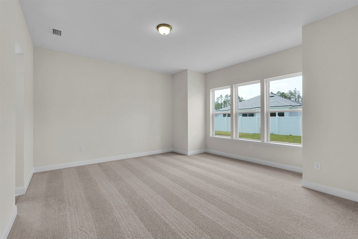 323 Sawgrass Drive Yulee, FL 32097 - Photo 22 of 33 wooden floor in an empty room with a window