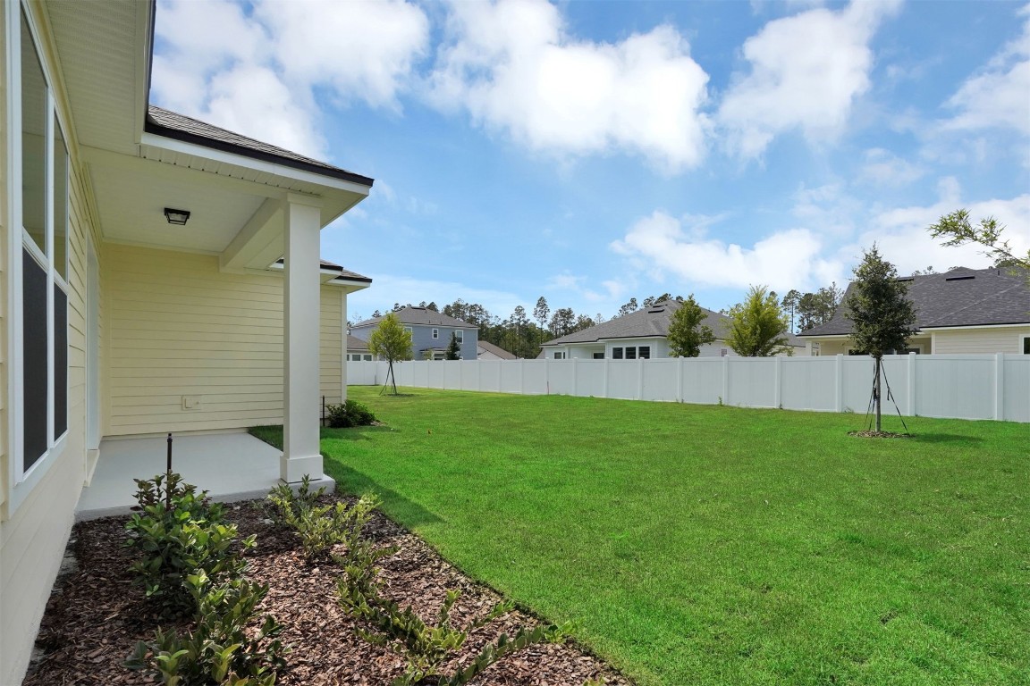323 Sawgrass Drive Yulee, FL 32097 - Photo 30 of 33 a backyard of a house with lots of green space