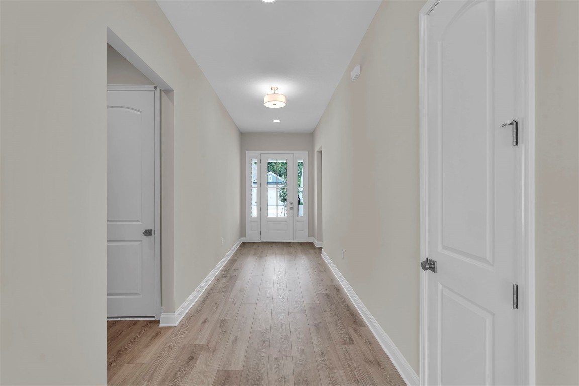 323 Sawgrass Drive Yulee, FL 32097 - Photo 6 of 33 a view of a hallway with wooden floor