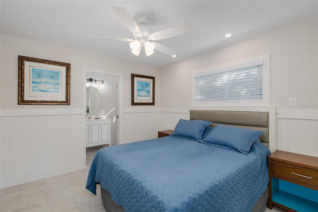 14616 Blessing Lane Hudson, FL 34667 - Photo 11 of 29 a bedroom with a large bed and a chandelier