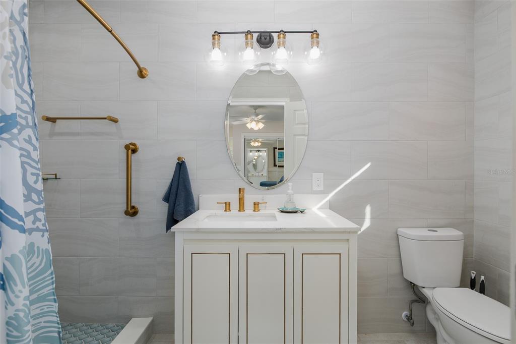 14616 Blessing Lane Hudson, FL 34667 - Photo 12 of 29 a bathroom with a toilet sink and mirror