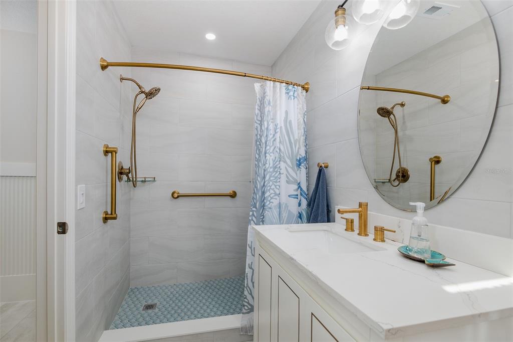 14616 Blessing Lane Hudson, FL 34667 - Photo 13 of 29 a bathroom with a sink vanity and a mirror
