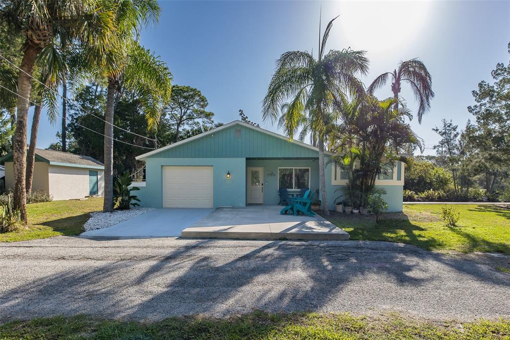 14616 Blessing Lane Hudson, FL 34667 - Photo 2 of 29 a front view of a house with a yard and garage
