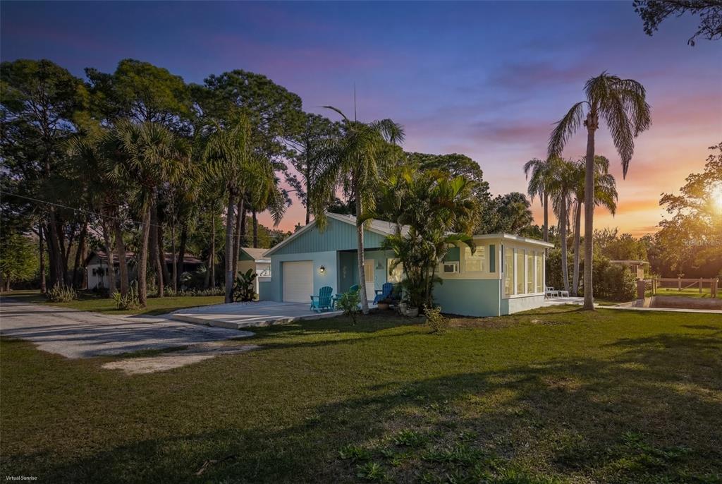 14616 Blessing Lane Hudson, FL 34667 - Photo 28 of 29 a front view of a house with a yard and trees