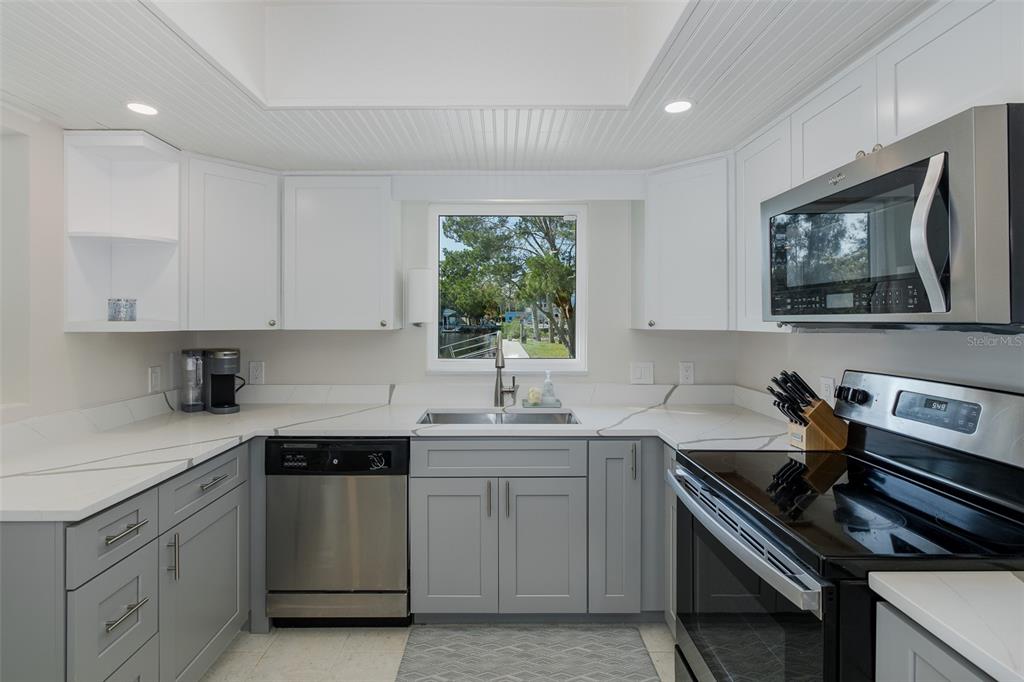 14616 Blessing Lane Hudson, FL 34667 - Photo 8 of 29 a kitchen with a sink stove and cabinets