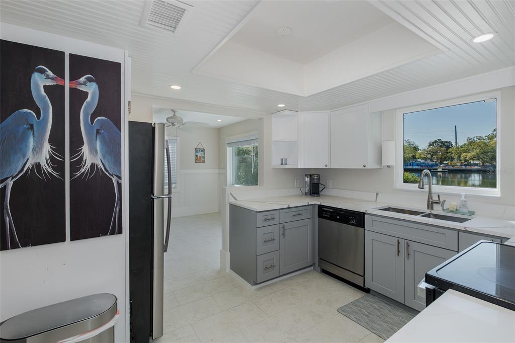14616 Blessing Lane Hudson, FL 34667 - Photo 9 of 29 a kitchen with stainless steel appliances granite countertop a sink and a refrigerator