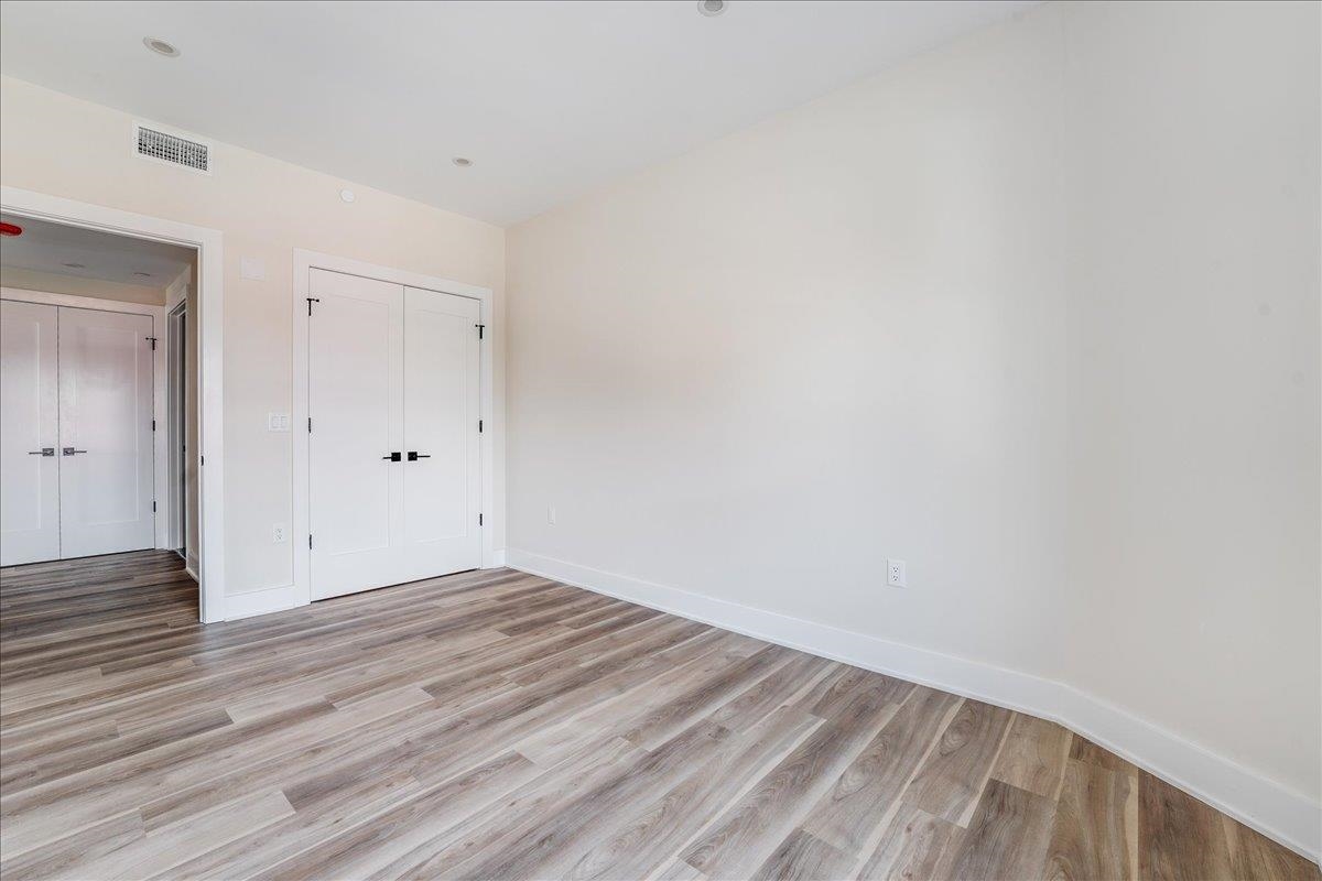 237 Washington Street, Unit 402 Hoboken, NJ 07030 - Photo 14 of 36 a view of an empty room with wooden floor