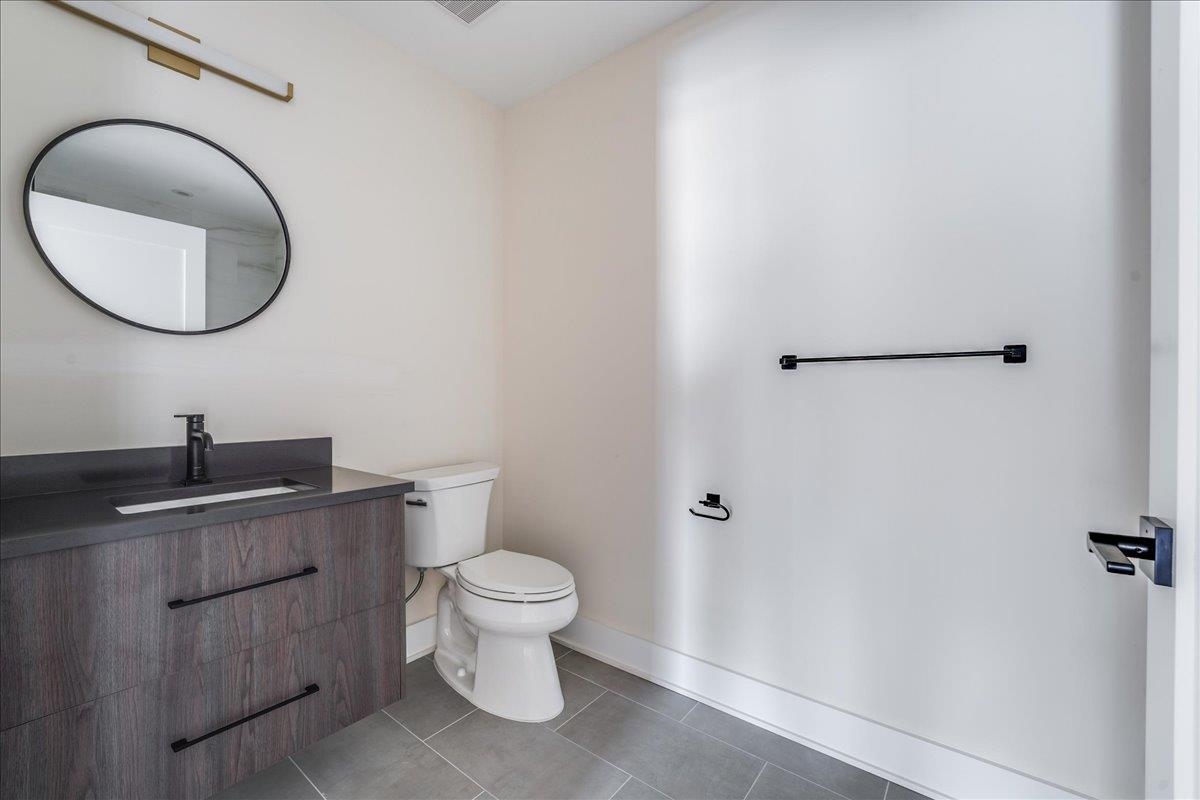 237 Washington Street, Unit 402 Hoboken, NJ 07030 - Photo 20 of 36 a bathroom with a granite countertop toilet and a sink