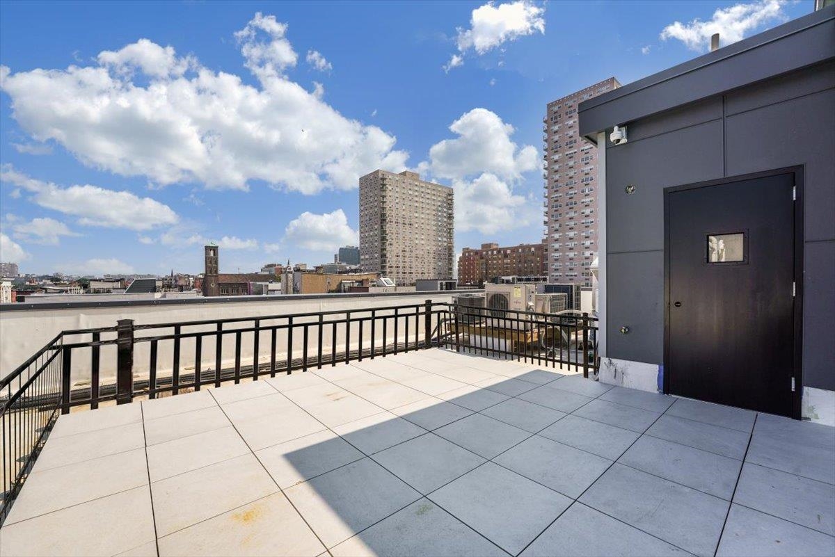 237 Washington Street, Unit 402 Hoboken, NJ 07030 - Photo 32 of 36 a terrace with a bench and city view