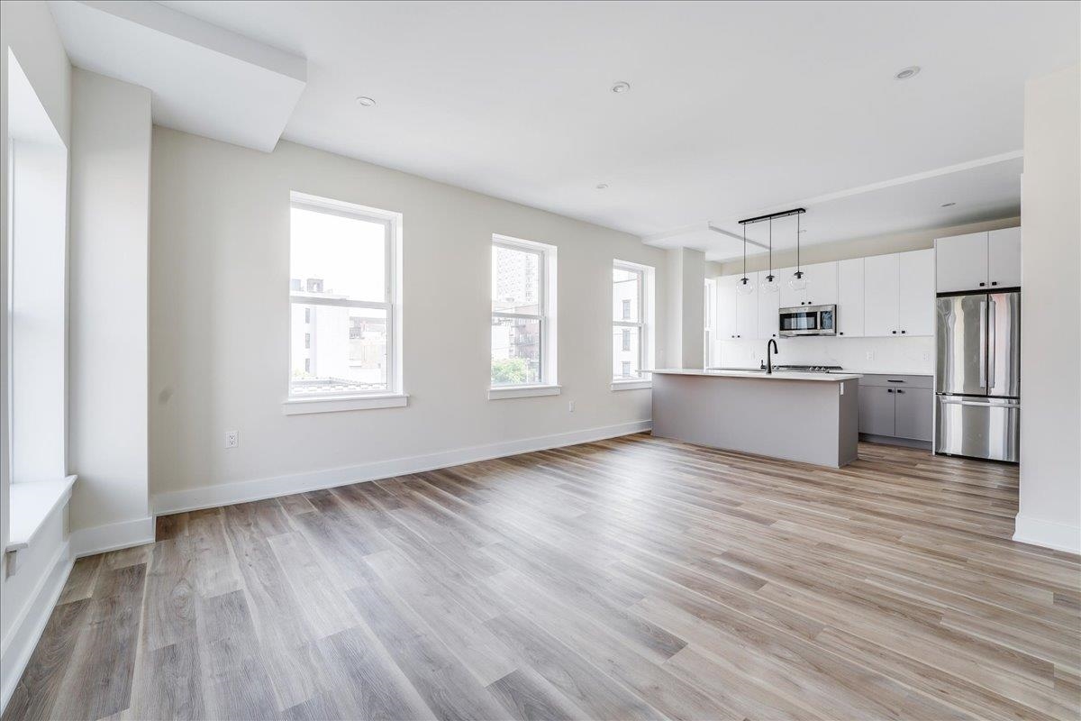 237 Washington Street, Unit 402 Hoboken, NJ 07030 - Photo 8 of 36 a view of a kitchen with wooden floor and a kitchen
