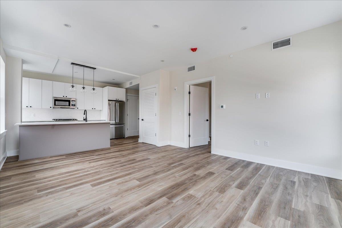 237 Washington Street, Unit 402 Hoboken, NJ 07030 - Photo 9 of 36 a view of kitchen with wooden floor