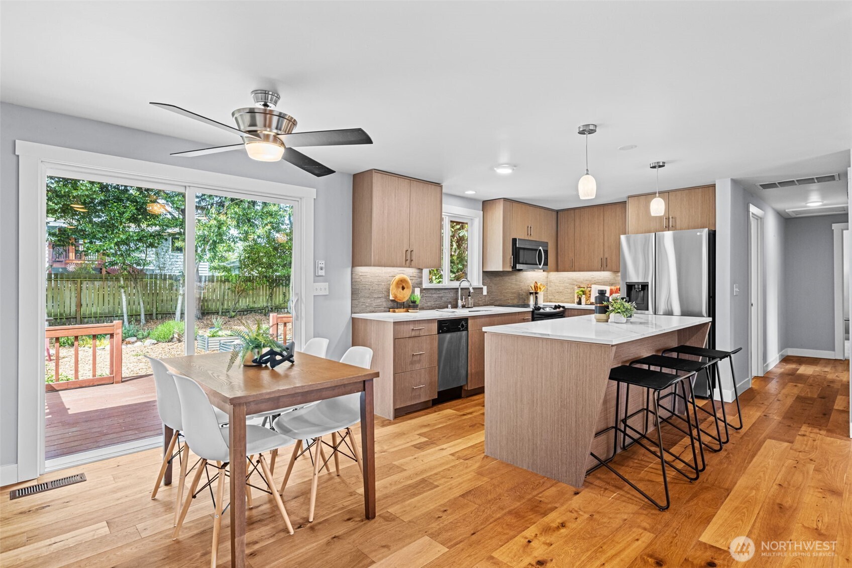 8629 223rd Street Southwest Edmonds, WA 98026 - Photo 11 of 40 a kitchen with a table chairs refrigerator and microwave