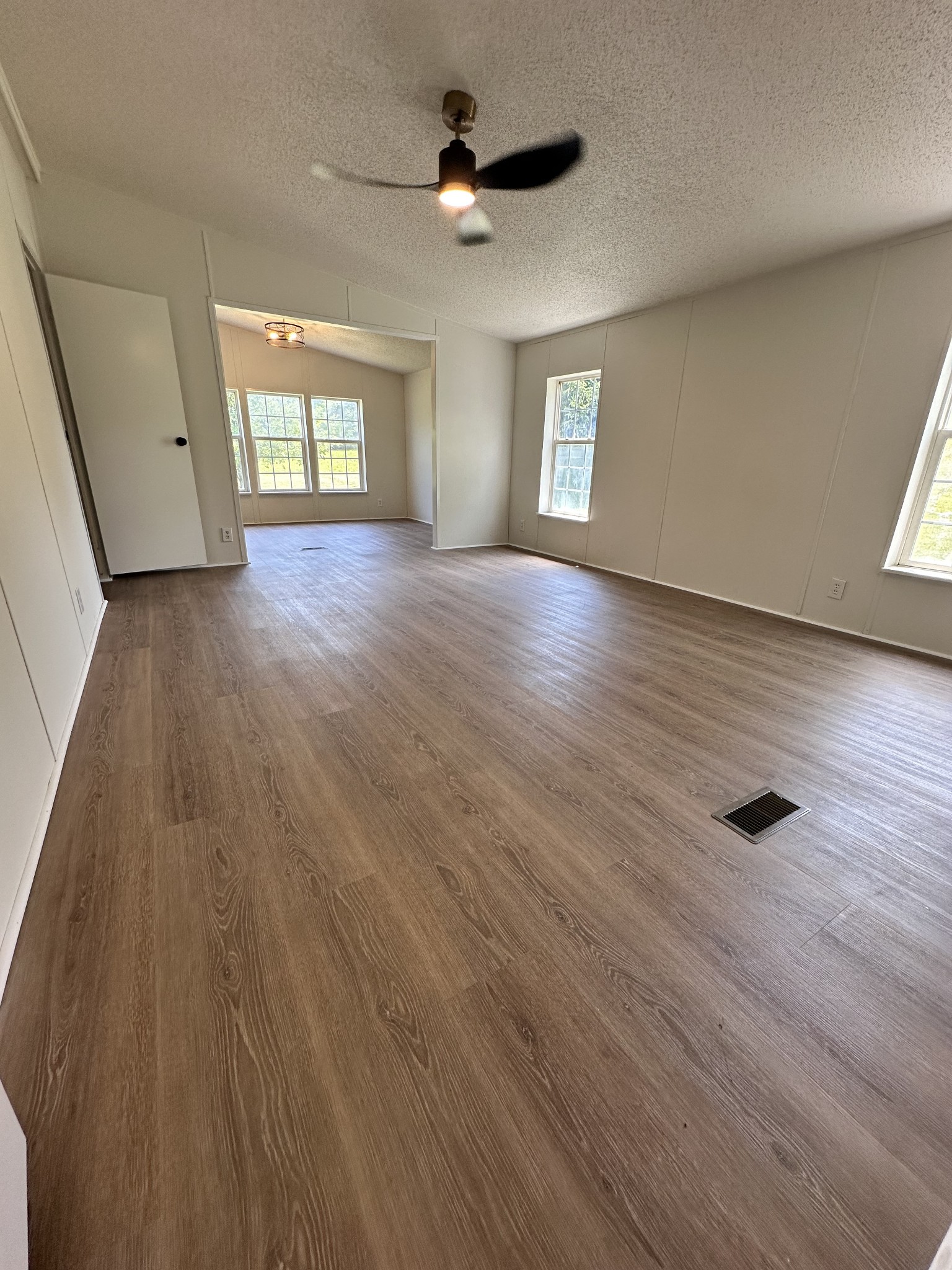 7287 Pinewood Road Nunnelly, TN 37137 - Photo 9 of 18 an empty room with wooden floor and windows
