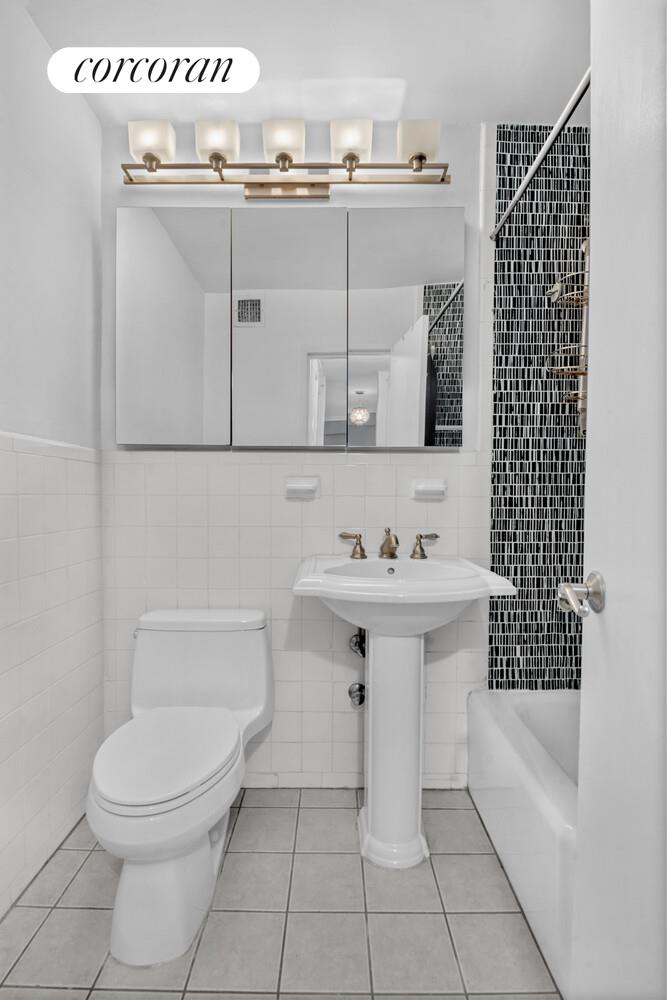 205 3rd Avenue, Unit 12A Manhattan, NY 10003 - Photo 10 of 11 a bathroom with a sink toilet and shower