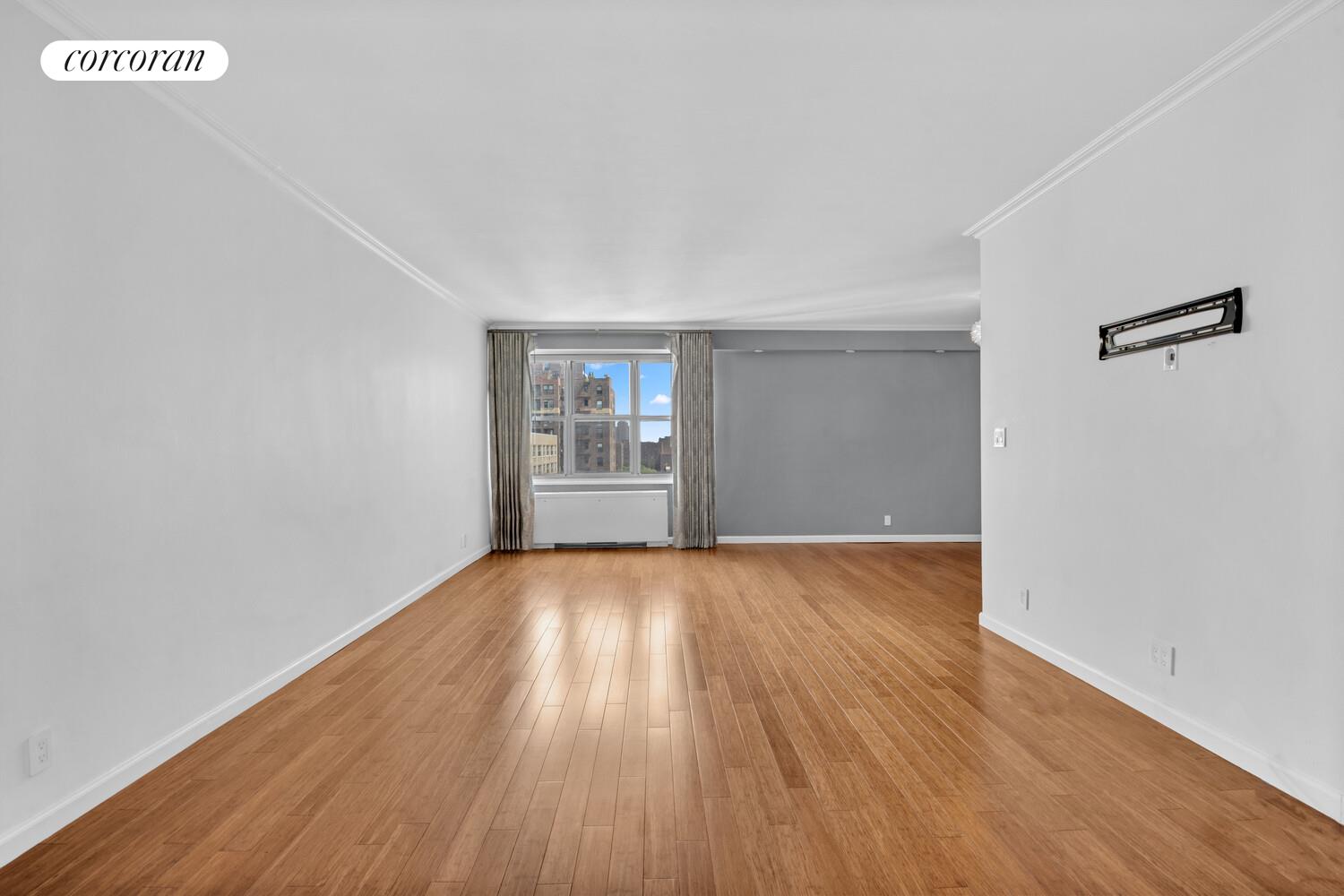 205 3rd Avenue, Unit 12A Manhattan, NY 10003 - Photo 2 of 11 an empty room with wooden floor and windows