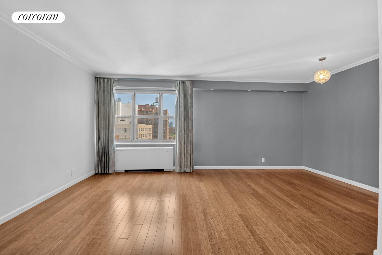 205 3rd Avenue, Unit 12A Manhattan, NY 10003 - Photo 6 of 11 a view of an empty room with wooden floor and a window