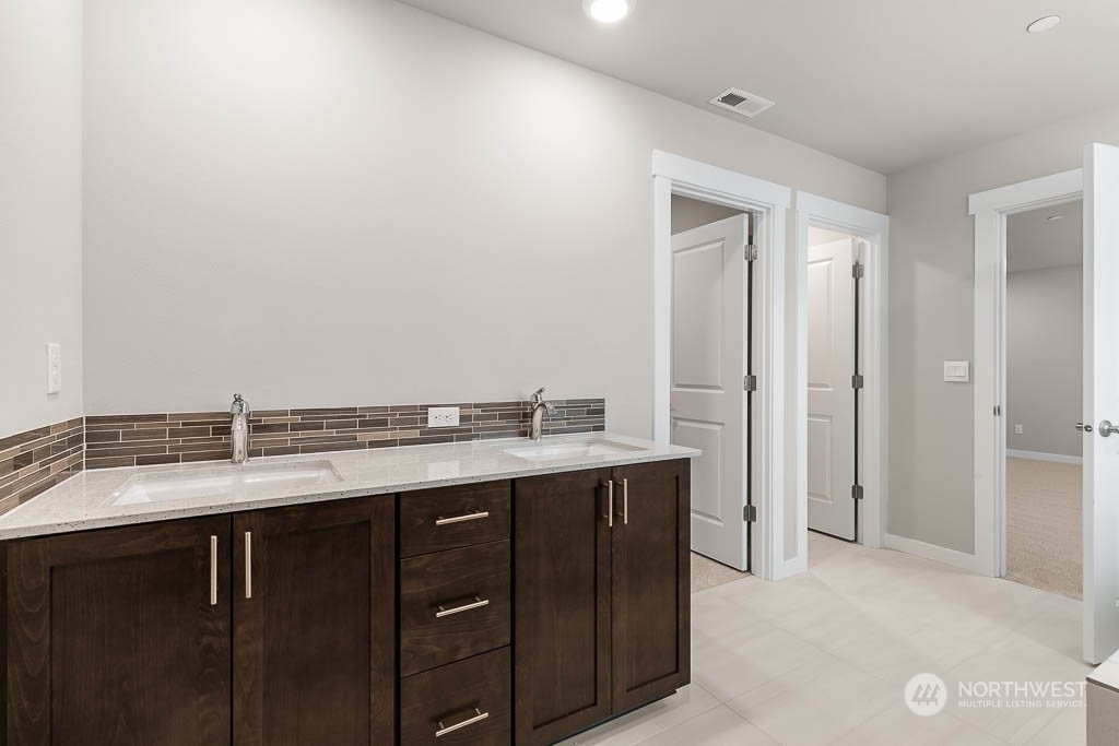 4403 228th Place South East, Unit 14 Bothell, WA 98021 - Photo 20 of 22 a bathroom with a granite countertop sink and a mirror