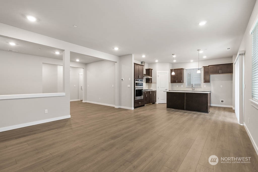 4403 228th Place South East, Unit 14 Bothell, WA 98021 - Photo 8 of 22 a view of kitchen with kitchen island wooden floor center island and stainless steel appliances