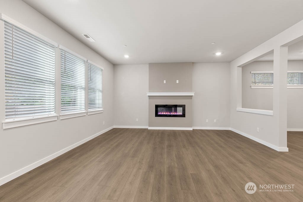 4403 228th Place South East, Unit 14 Bothell, WA 98021 - Photo 9 of 22 an empty room with windows and fireplace