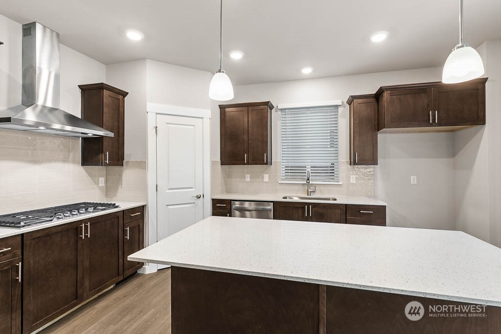 4403 228th Place South East, Unit 14 Bothell, WA 98021 - Photo 10 of 22 a kitchen with kitchen island a sink stainless steel appliances and counter space