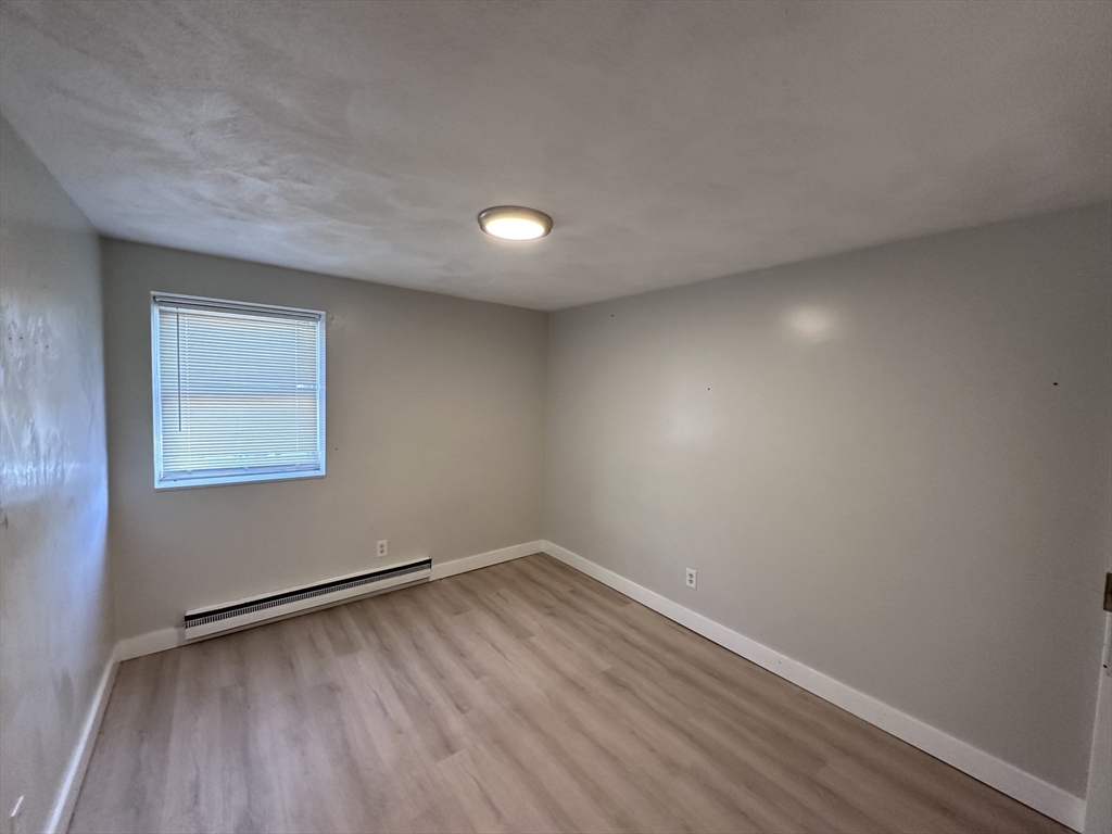 20 Hy-Sil Avenue, Unit 7 Chelsea, MA 02151 - Photo 3 of 9 a view of room with window and wooden floor