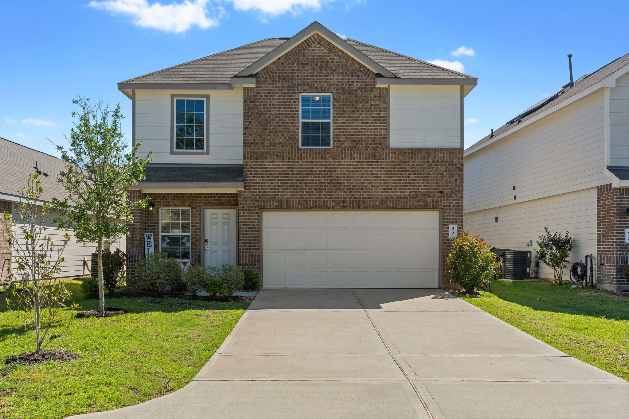 2221 Raider Drive Conroe, TX 77301 - Photo 1 of 42 a front view of a house with a yard and garage