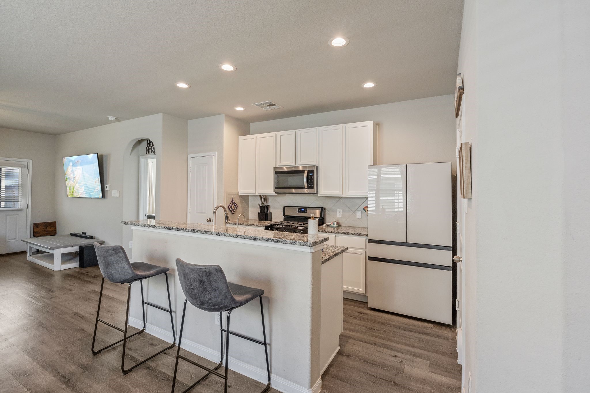 2221 Raider Drive Conroe, TX 77301 - Photo 12 of 42 a kitchen with stainless steel appliances granite countertop a refrigerator and a stove top oven
