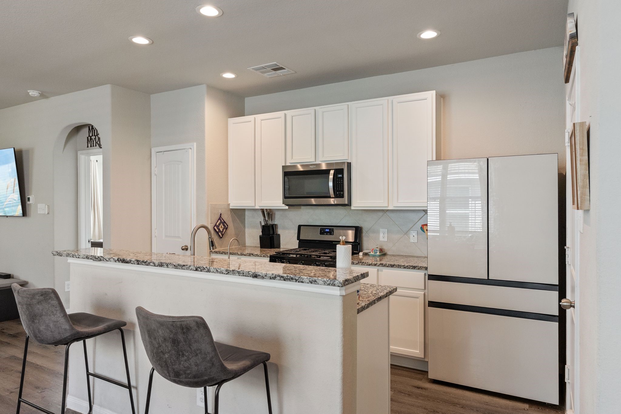 2221 Raider Drive Conroe, TX 77301 - Photo 13 of 42 a kitchen with stainless steel appliances granite countertop a refrigerator and a stove top oven