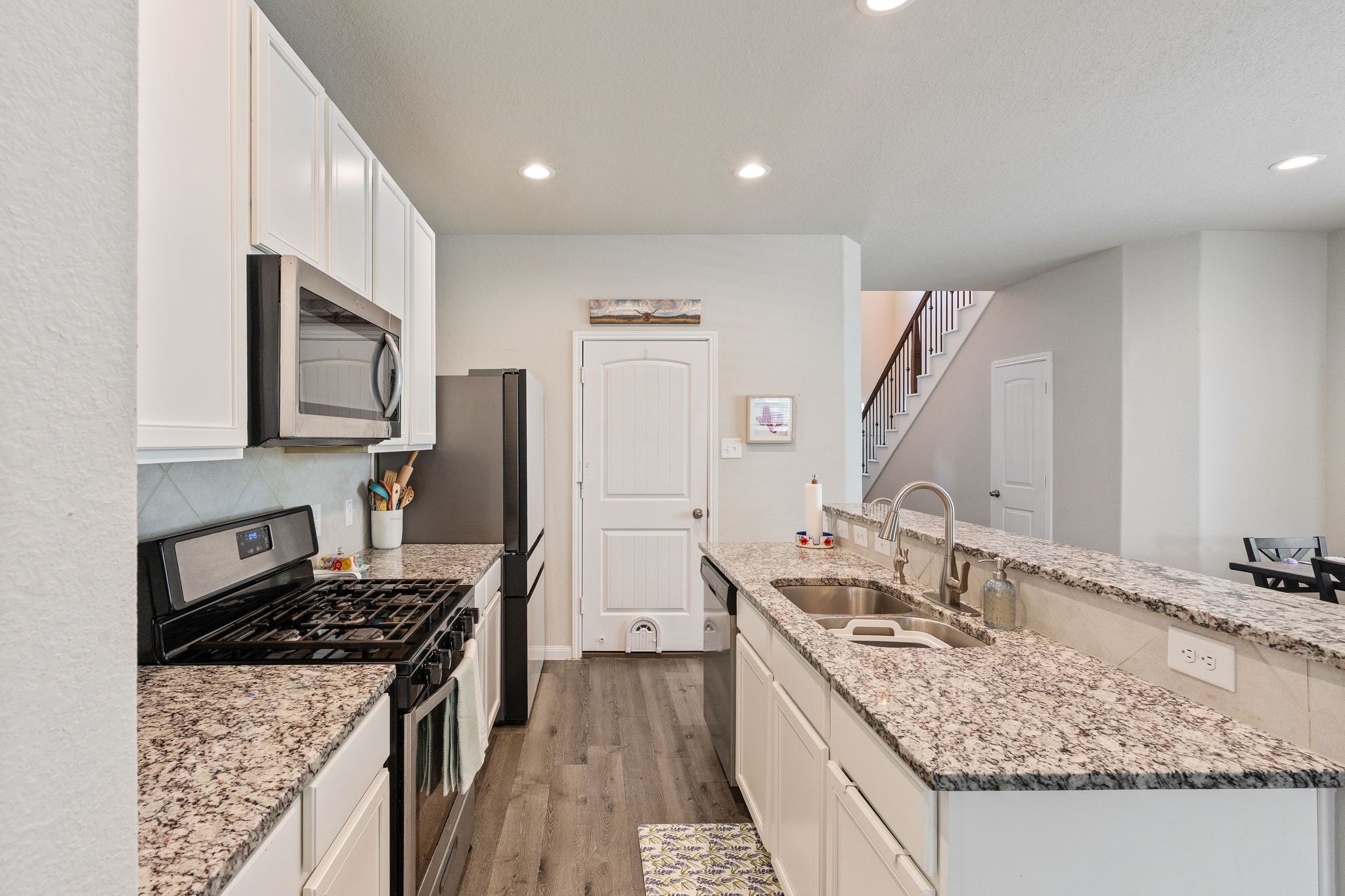 2221 Raider Drive Conroe, TX 77301 - Photo 15 of 42 a kitchen with a sink stove and refrigerator