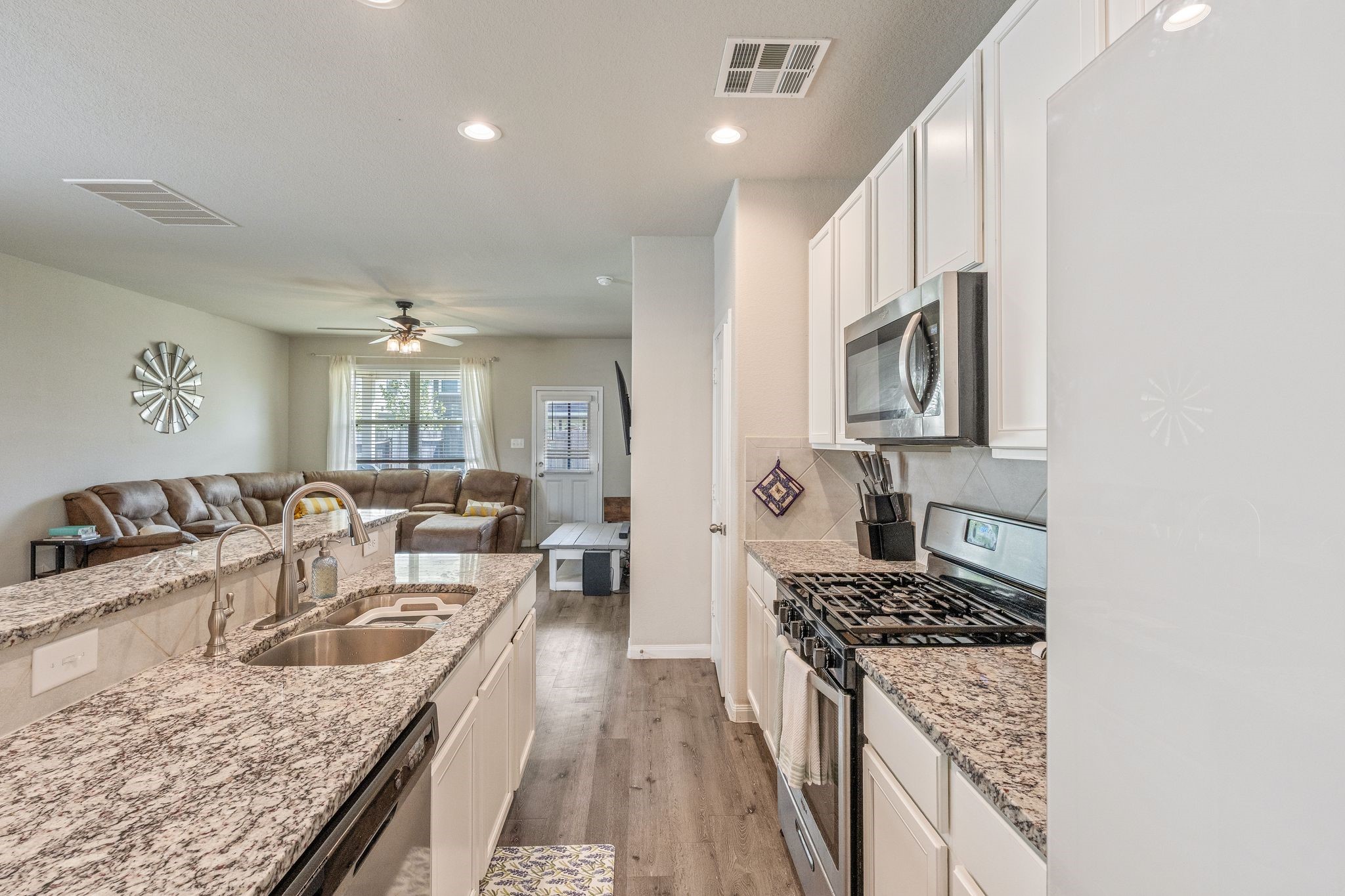 2221 Raider Drive Conroe, TX 77301 - Photo 16 of 42 a kitchen with granite countertop stainless steel appliances lots of counter top space