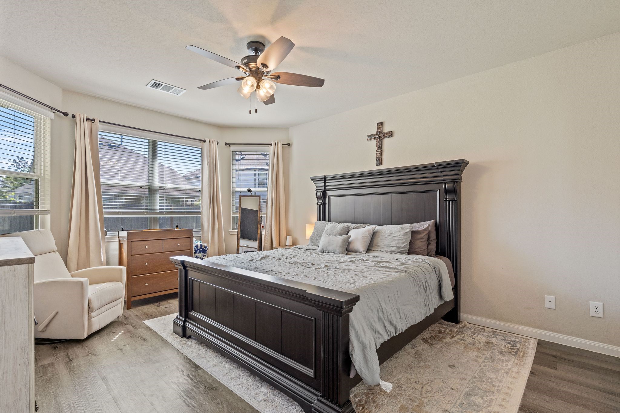 2221 Raider Drive Conroe, TX 77301 - Photo 21 of 42 a bedroom with a bed and a chandelier
