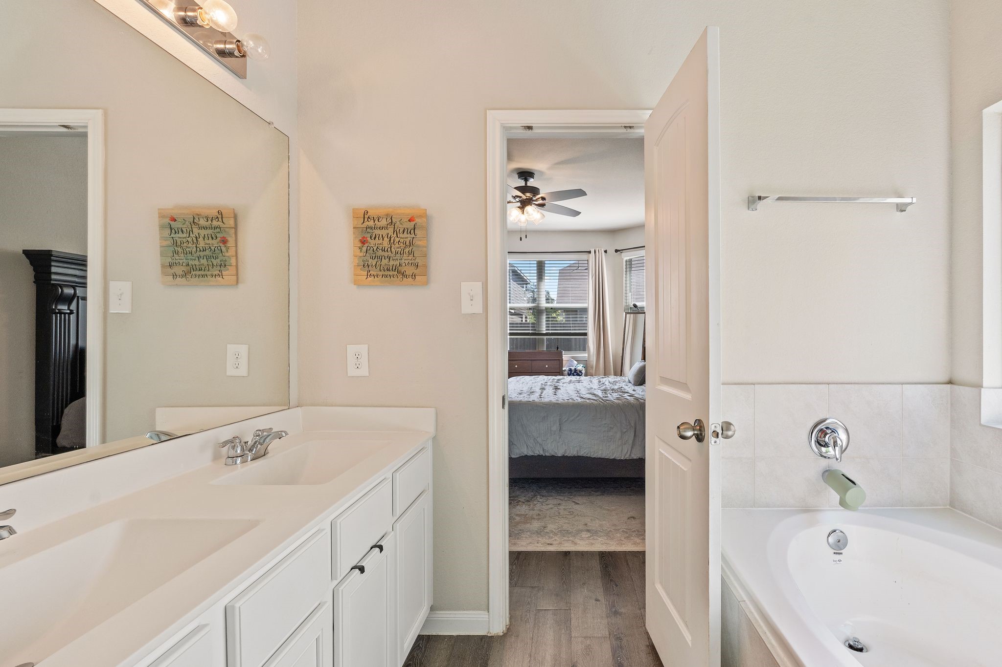 2221 Raider Drive Conroe, TX 77301 - Photo 27 of 42 a bathroom with a tub sink and mirror