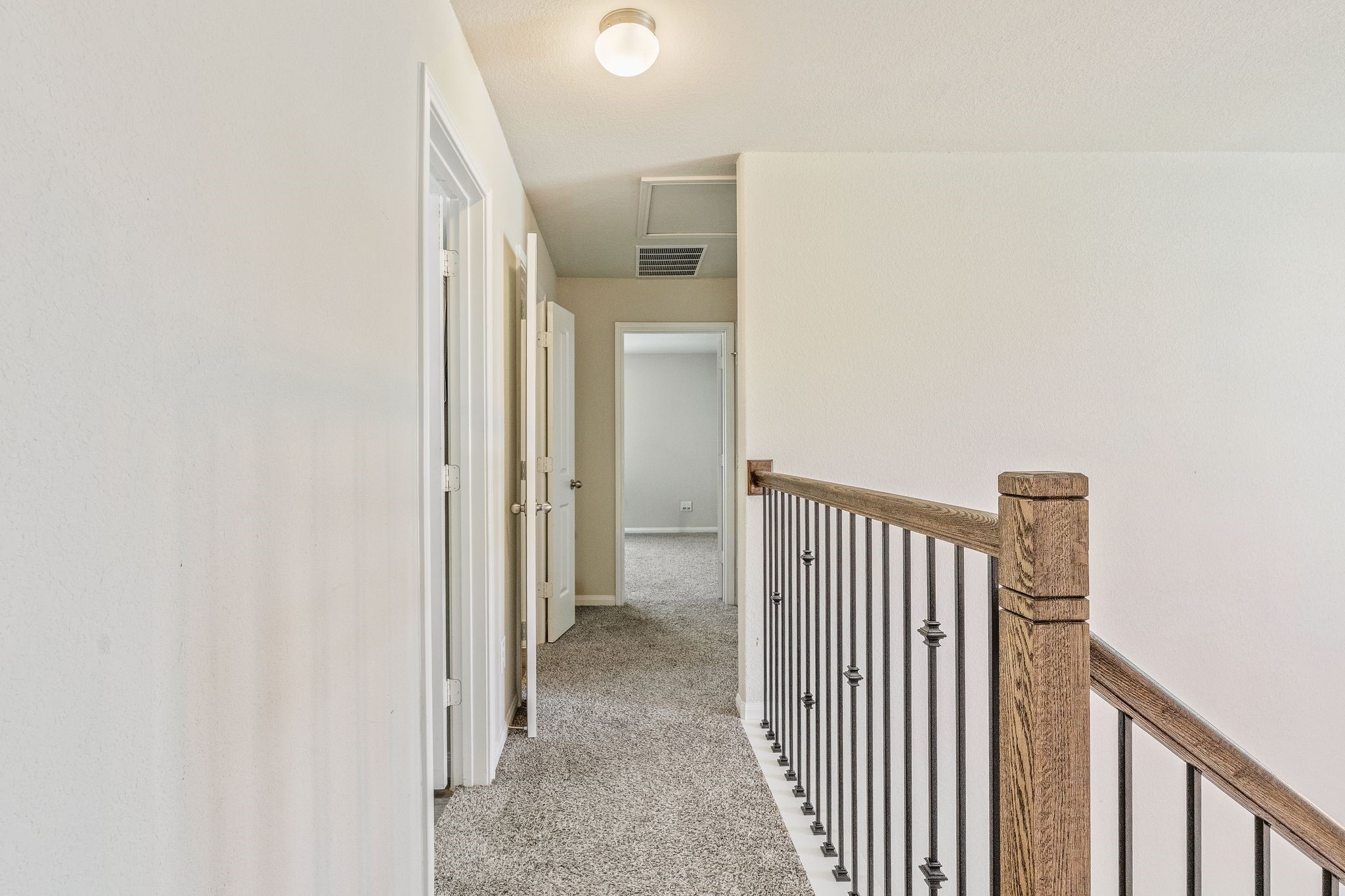 2221 Raider Drive Conroe, TX 77301 - Photo 33 of 42 a view of a hallway with wooden floor and a bathroom