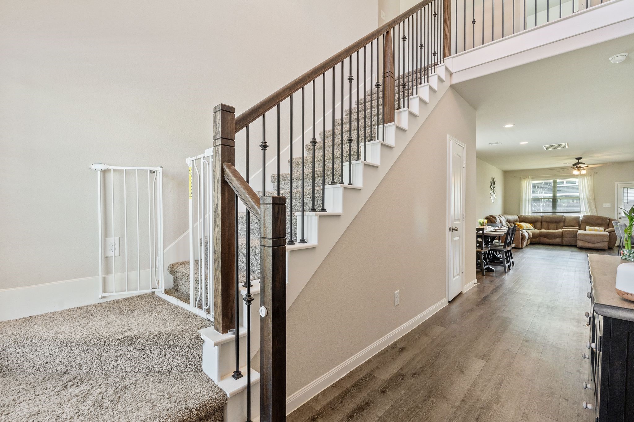 2221 Raider Drive Conroe, TX 77301 - Photo 5 of 42 a view of a livingroom with wooden floor and stairs