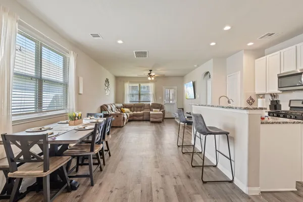 a view of a dining room with furniture and windows