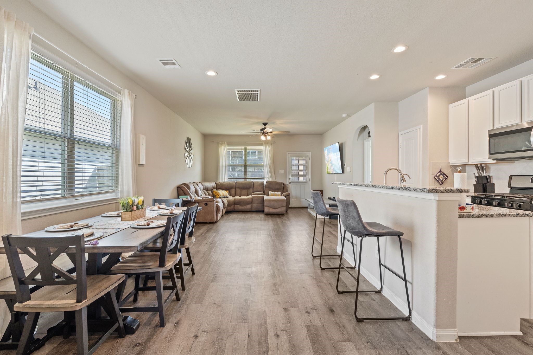 2221 Raider Drive Conroe, TX 77301 - Photo 6 of 42 a view of a dining room with furniture and a wooden floor