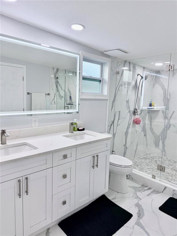 2719 West Braddock Street Tampa, FL 33607 - Photo 18 of 29 a bathroom with a sink a toilet and shower