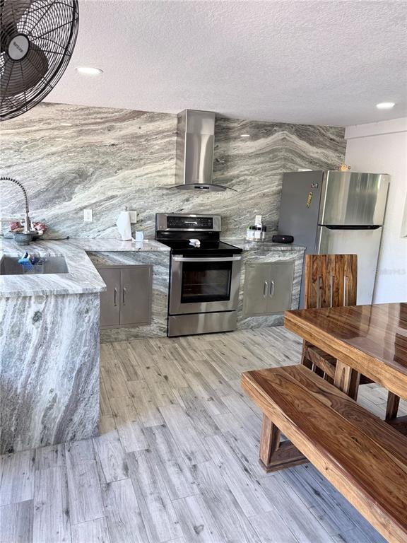 2719 West Braddock Street Tampa, FL 33607 - Photo 26 of 29 a kitchen with stainless steel appliances wooden floors and wooden cabinets