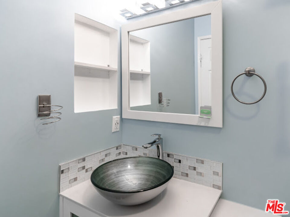 15511 Sherman Way, Unit 17 Van Nuys, CA 91406 - Photo 13 of 47 a room with a chandelier fan and windows